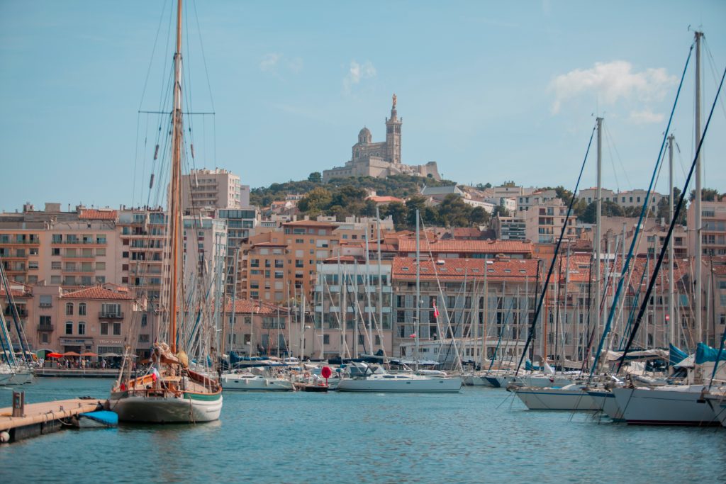 Old Port of Marseille with moored sailing boats and Notre-Dame-de-la-Garde in the background